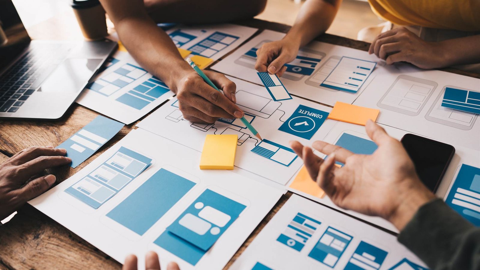Designers sketching mobile app wireframes