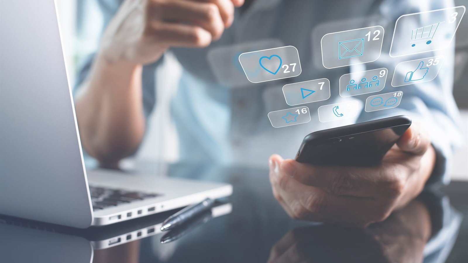 Person using a smartphone with social media engagement icons