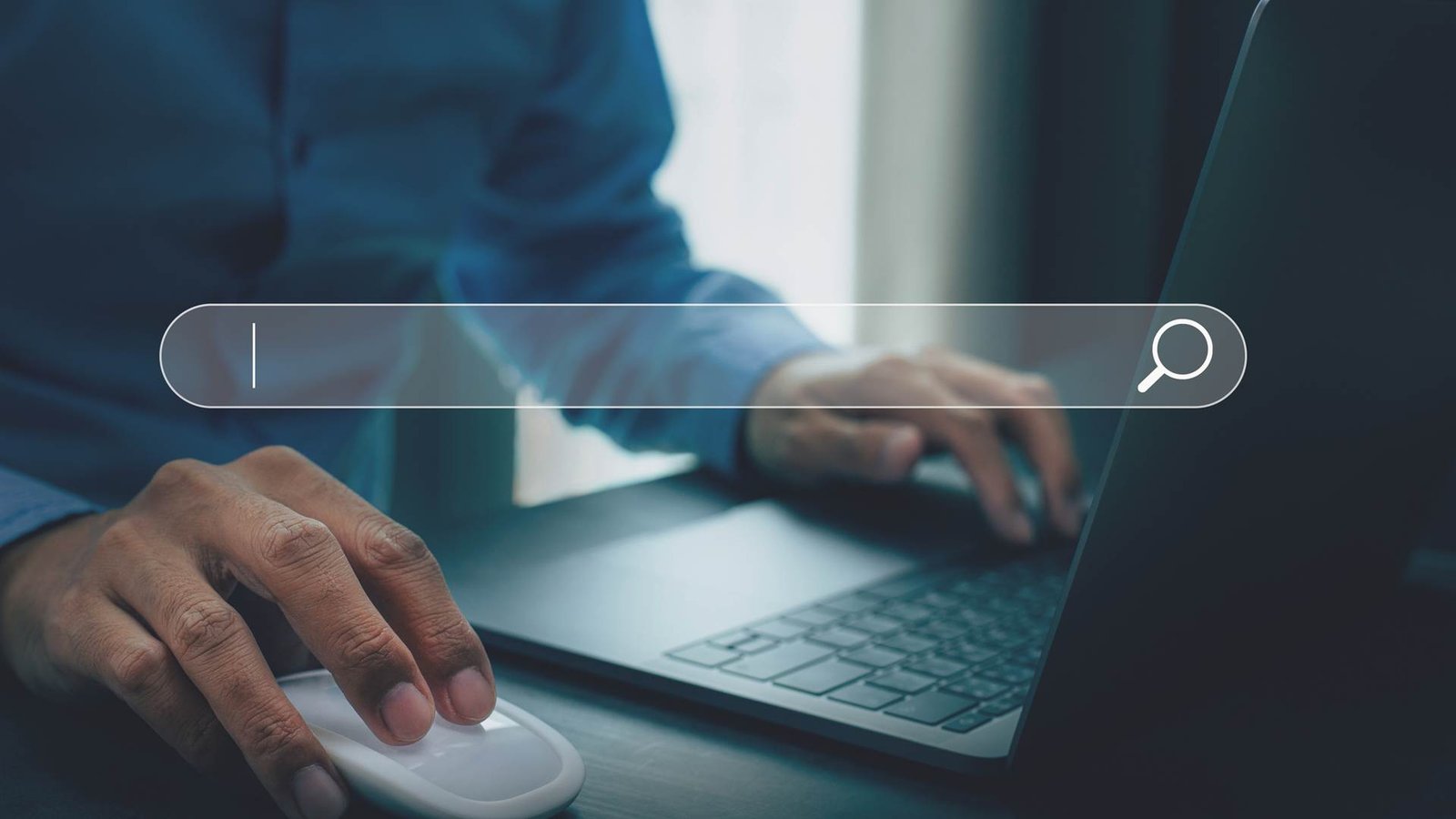 Hands on a laptop searching the web