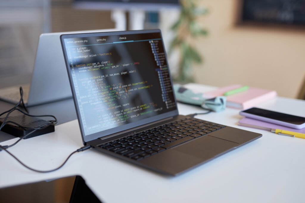 Laptop with codes on screen standing on desk of B'Skale Solutionz
